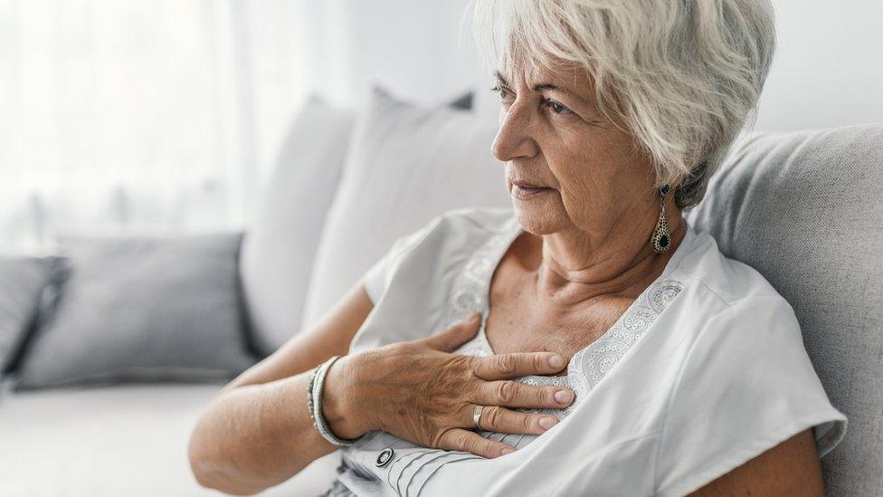 Woman holding her chest