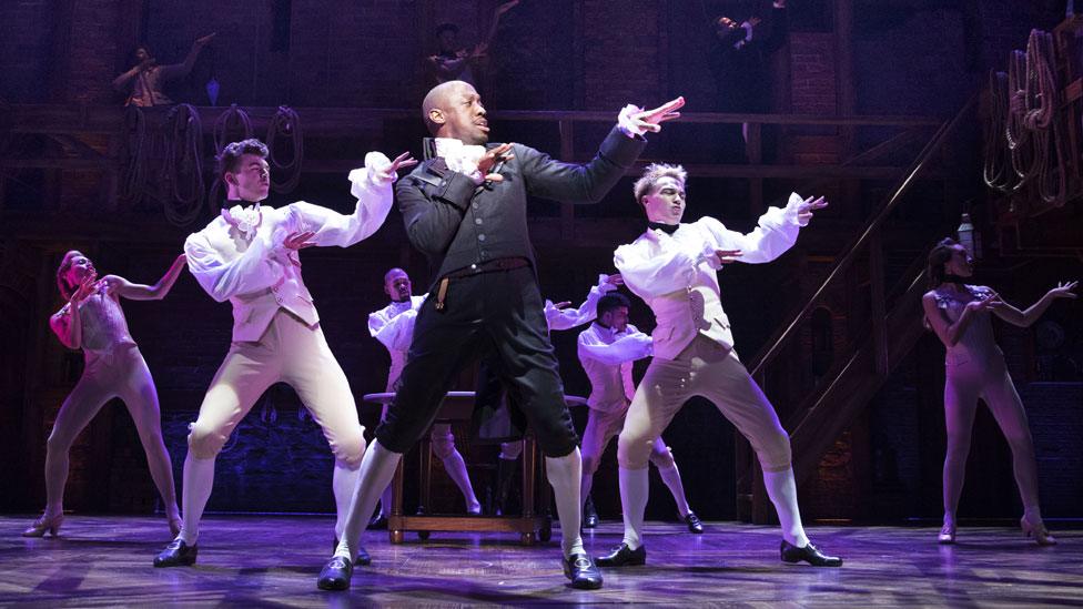 Giles Terera (centre) as Aaron Burr in Hamilton