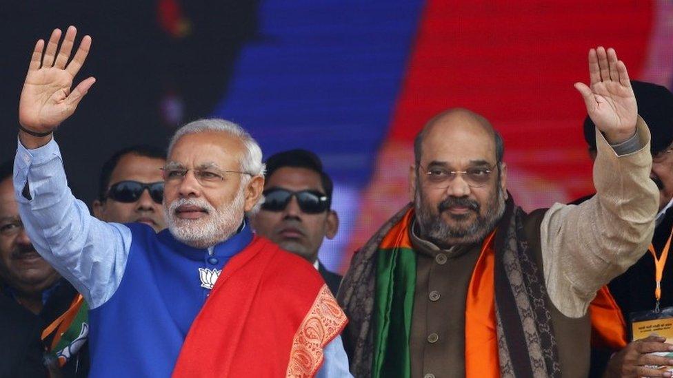 Indian Prime Minister Narendra Modi (L) and Amit Shah, the president of India"s ruling Bharatiya Janata Party (BJP), wave to their supporters during a campaign rally ahead of state assembly elections, at Ramlila ground in New Delhi in this January 10, 2015 file photo