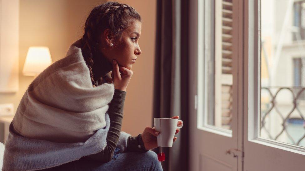 Woman looking out of window