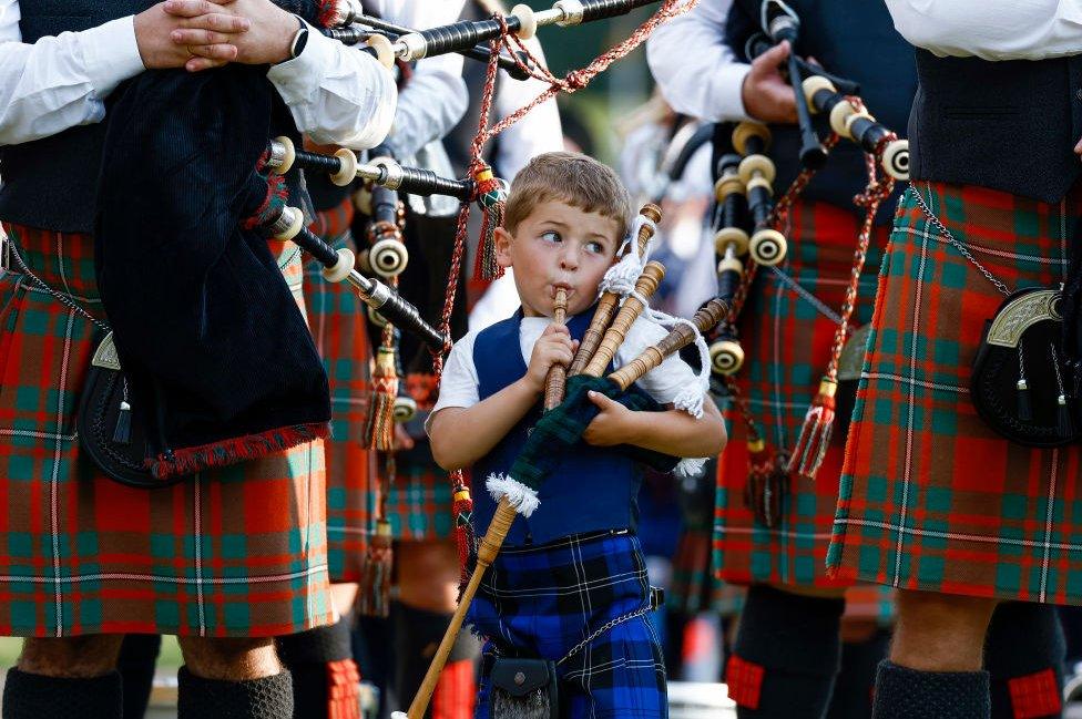 Young boy plays his bagpipes