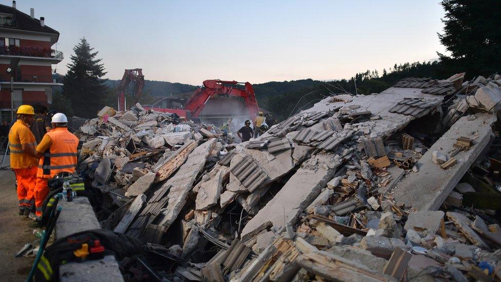 emergency workers search through rubble in Amatrice