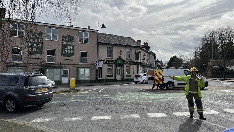 Council workers at a roadabout where an oil spill occured