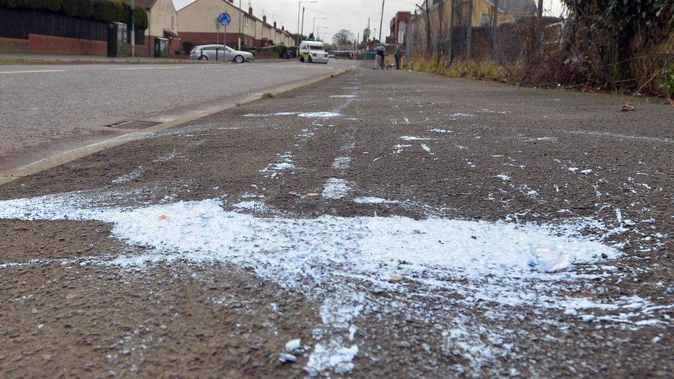 A paint bomb stain on the road where the rioting took place