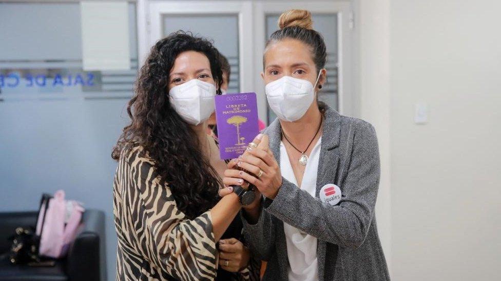 Consuelo Morales and Pabla Heuser hold up their marriage certificate