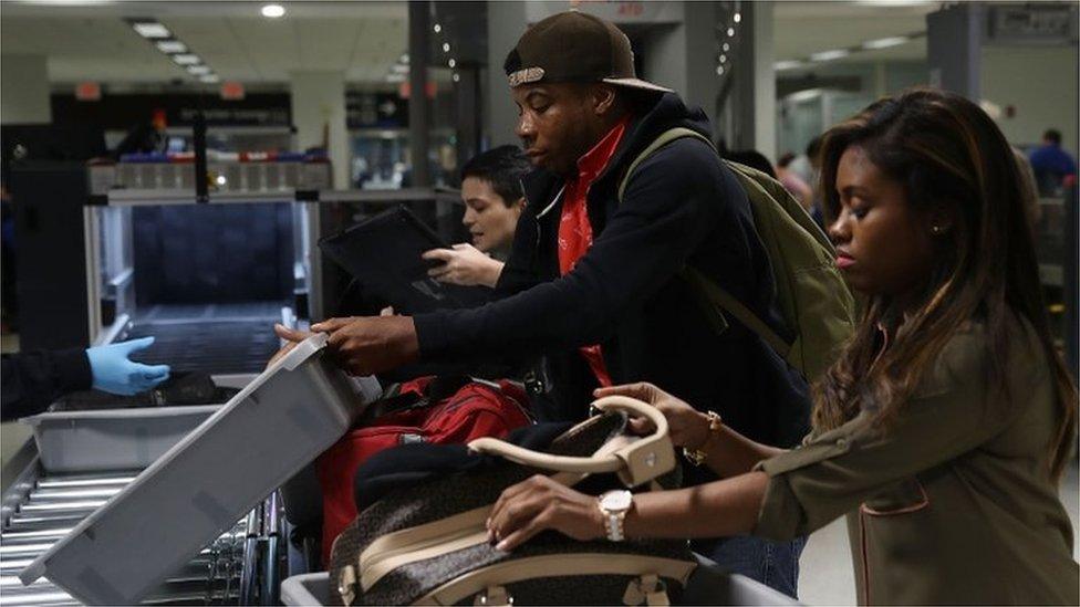 Passengers at an airport security screening