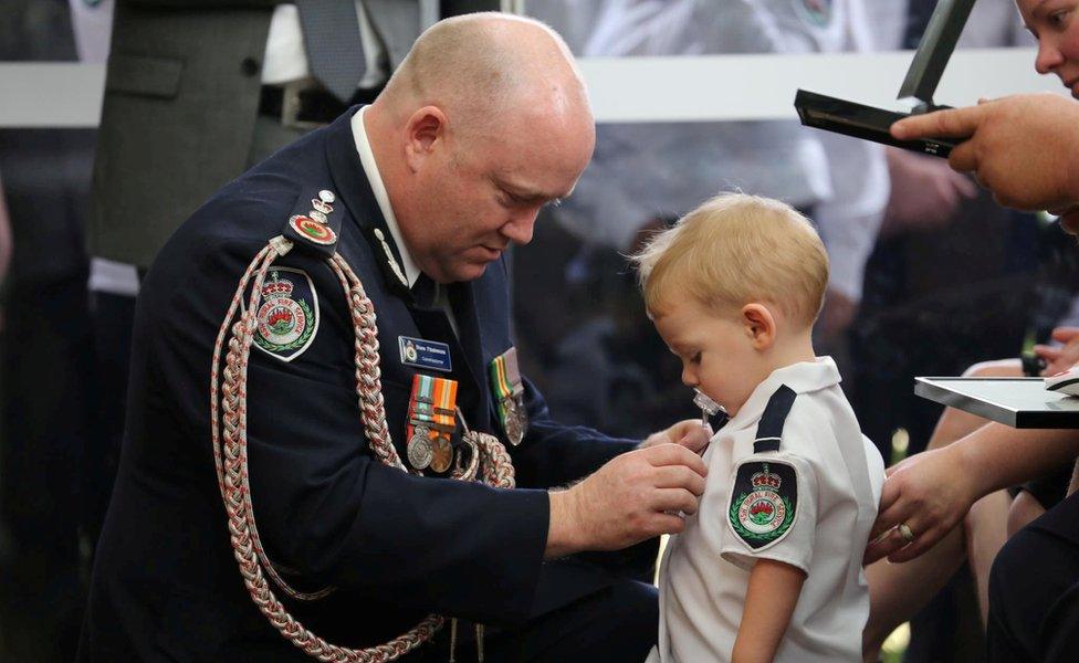 This photo of the commissioner and 19-month-old Harvey Keaton was widely shared online