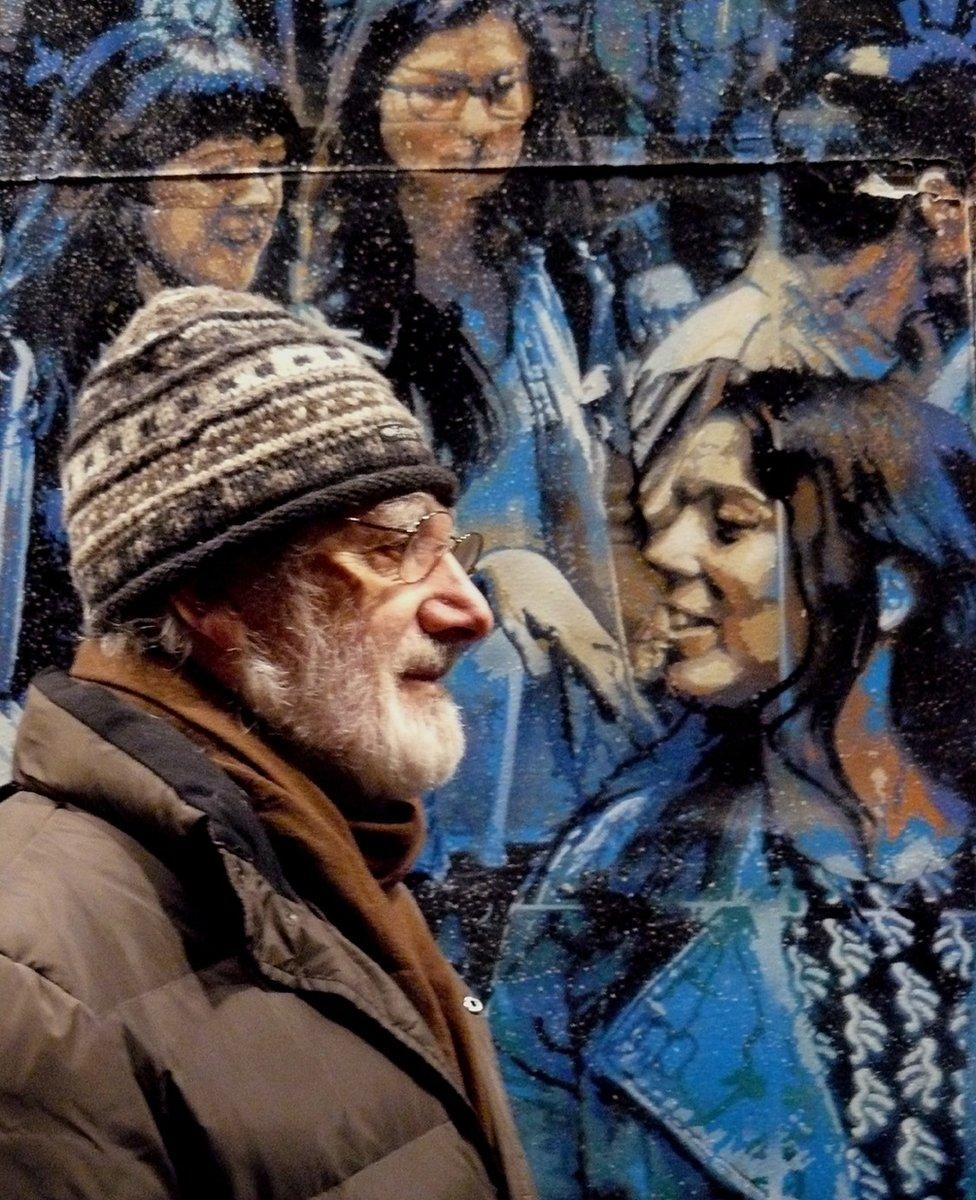 Man passing a mural