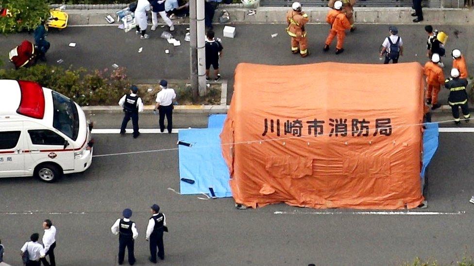 An aerial view shows rescue workers and police officers operate at the site where sixteen people were injured in a suspected stabbing by a man, in Kawasaki, 28 May 2019