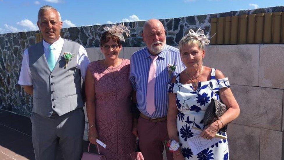 Two couples dressed for a wedding