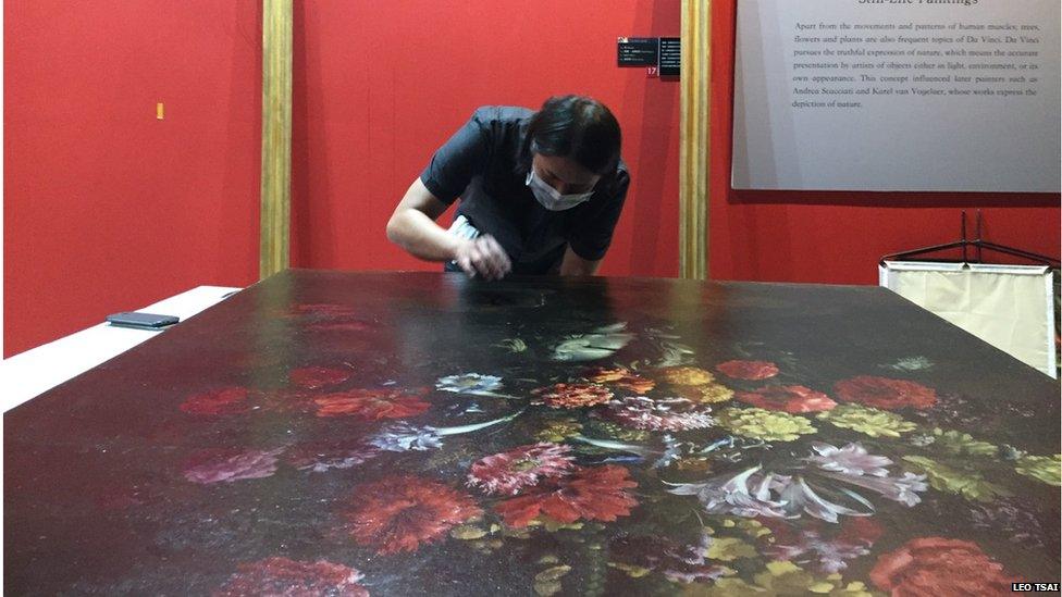 Picture of Taiwanese art restorer patching up the 17th century painting