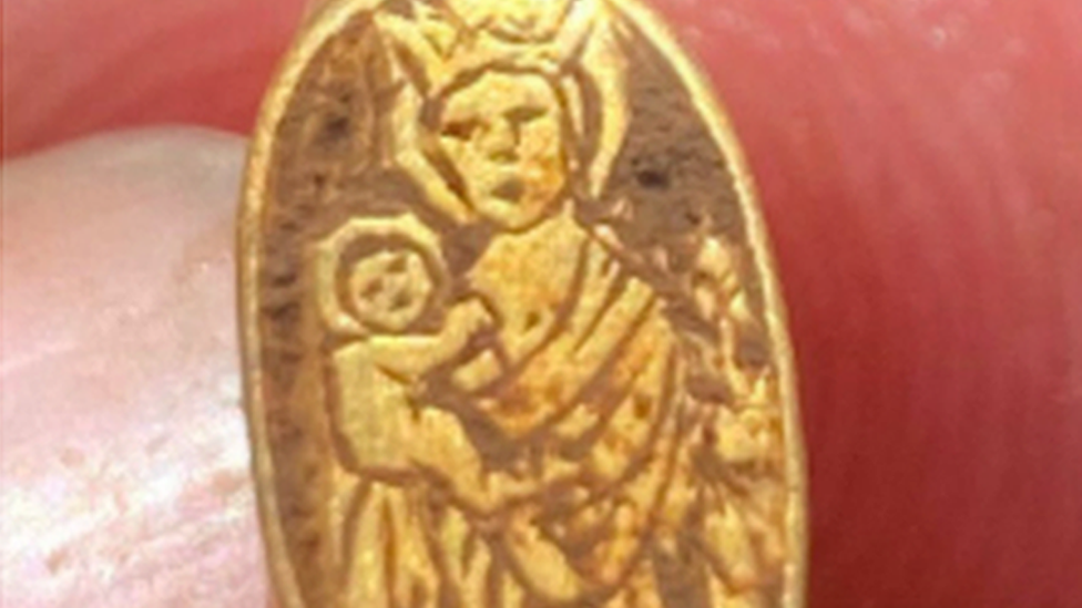 The ring featuring baby Jesus being held by the Virgin Mary