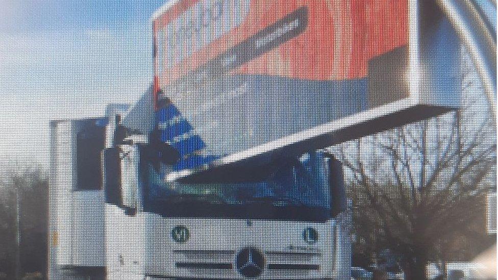 Road sign embedded in lorry window