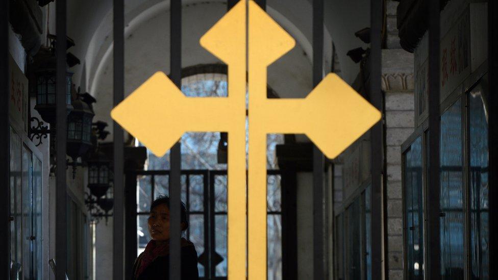 A Chinese Catholic (back L) arrives to attend a church service at the East Cathedral in Beijing on February 19, 2013