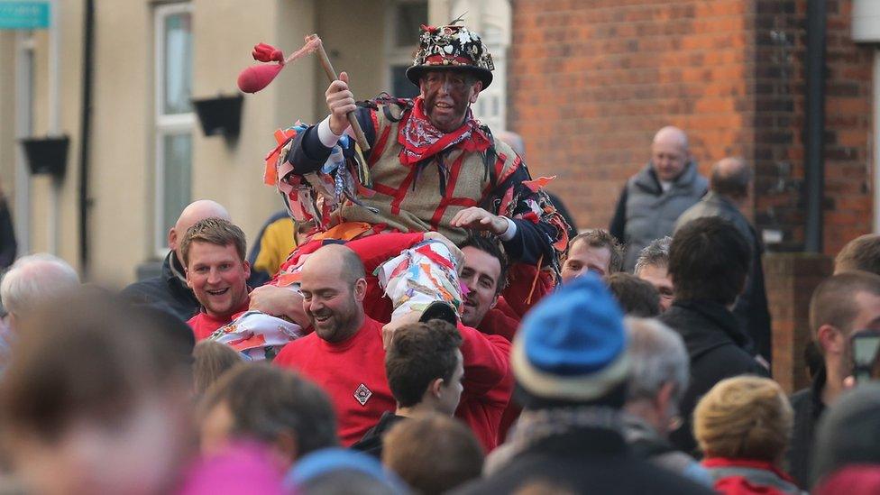 The Haxey Fool, Dale Smith, is carried through the village to start the Haxey Hood Game at