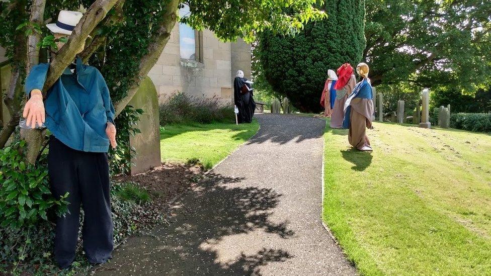 Scarecrows in churchyard