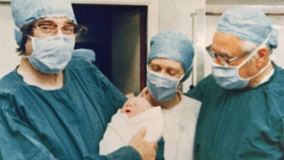 IVF pioneers Robert Edwards (L) and Patrick Steptoe (R) pose with Louise following her birth