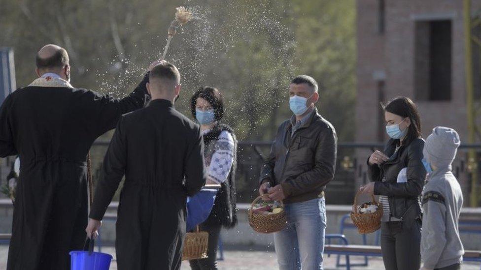 An Orthodox priest blesses believers in Lviv, Ukraine. Photo: 18 April 2020