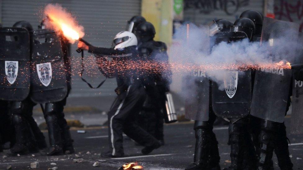 Riot police clash with demonstrators during protests over the ending of four-decade-old fuel subsidies