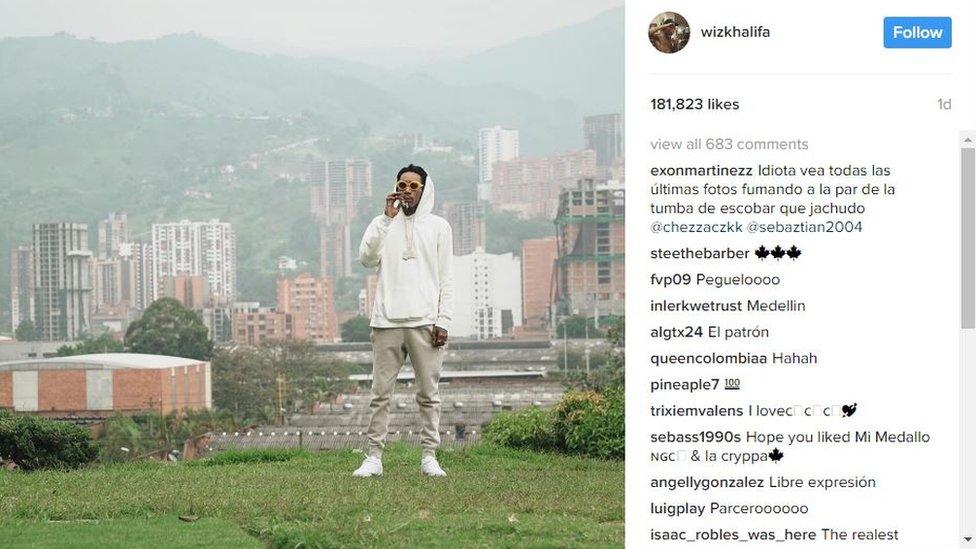 Screengrab from the Instagram account of Wiz Khalifa showing him smoking by the grave of the late Colombian drug lord Pablo Escobar