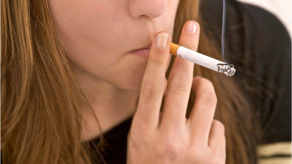 Young girl smoking a cigarette