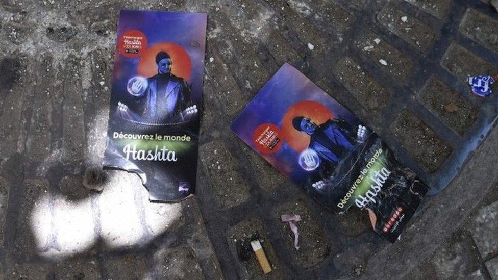 A picture shows on August 23, 2019, flyers of rapper Soolking lying on the ground outside Algiers" August-20 Stadium where five young people were killed and dozens more injured in a stampede at a packed concert by the musician the previous night.