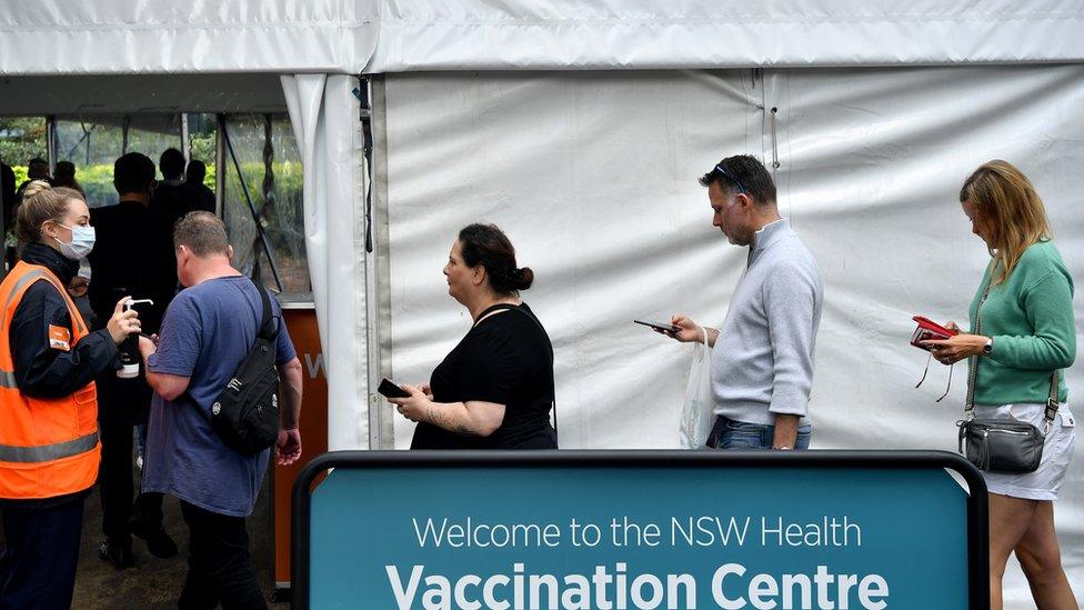 A queue of people waiting to get vaccinated at a mass vaccination hub in Sydney