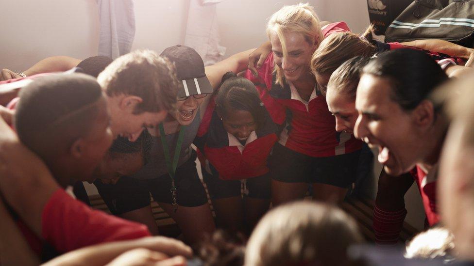 Women rugby players in a huddle