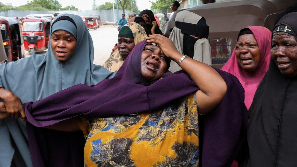 A woman reacts after receiving the confirmation that her son was killed in a suicide bombing attack on a military base, at the Madina Hospital in Mogadishu