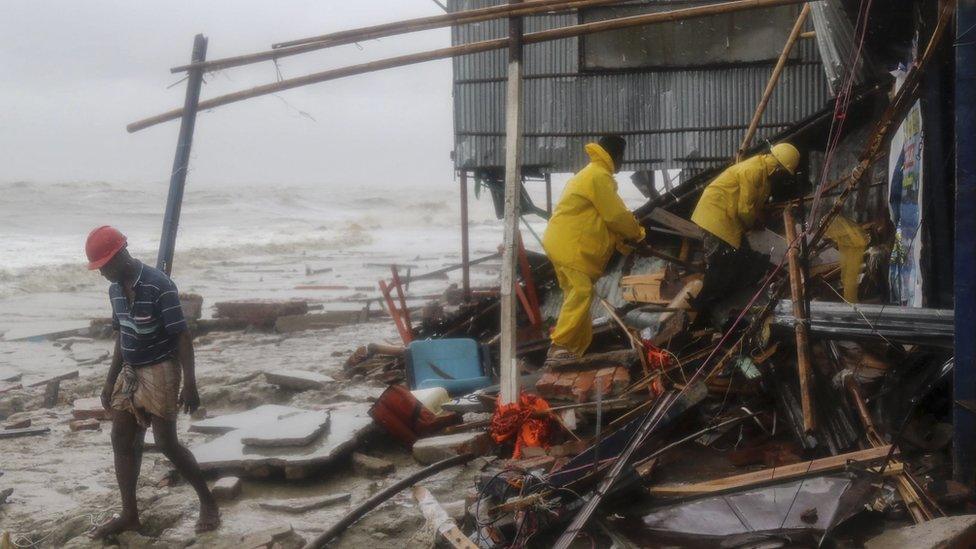 Rescue workers search for survivors after a cyclone in Bangladesh