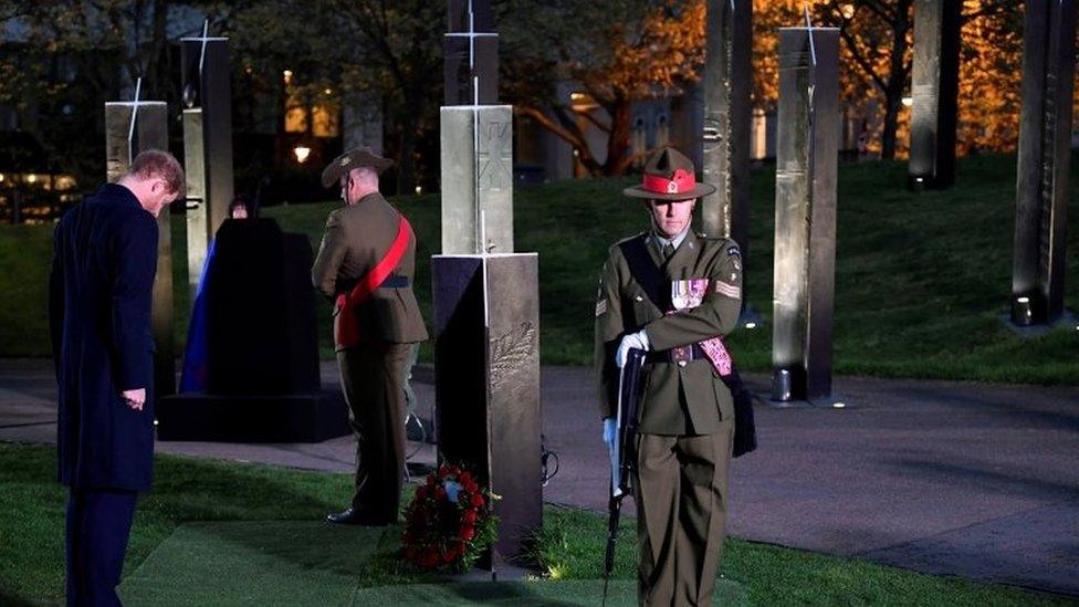 Prince Harry pays his respects after laying a wreath during the Dawn Service at Wellington Arch