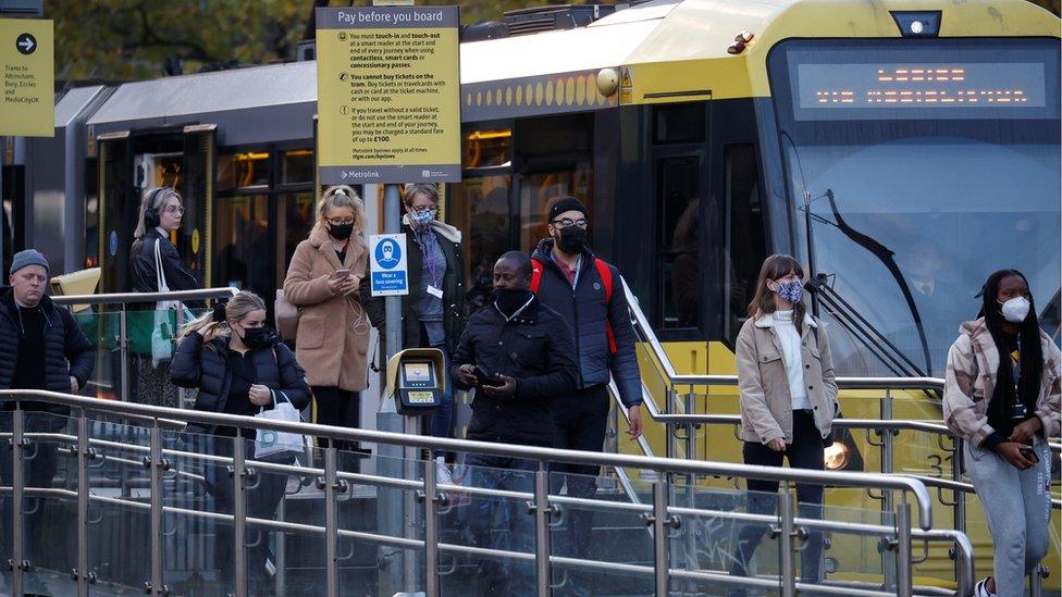 Passengers leave tram at station