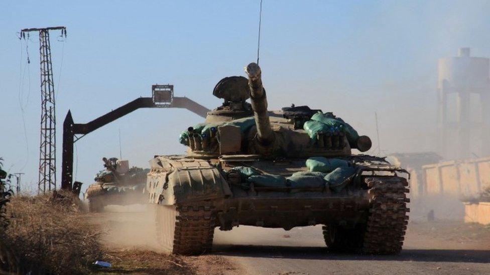 A Syrian government forces tank drives in the village of Tal Jabin, north of the embattled city of Aleppo (03 February 2016)