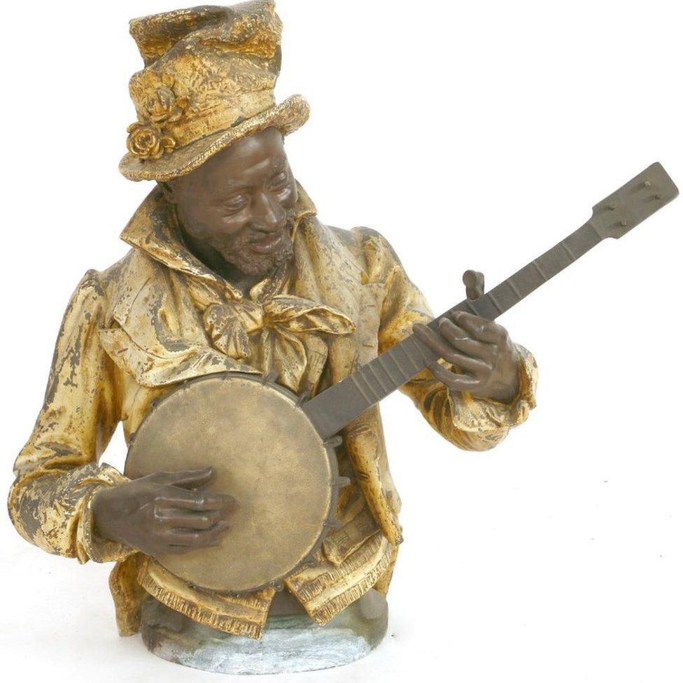 A cold painted spelter figure of a black musician