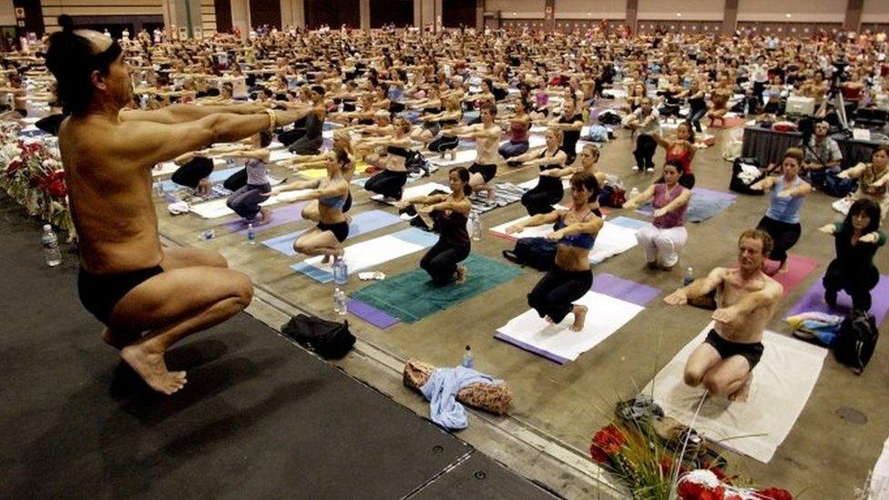 In this Sept. 27, 2003, file photo, Bikram Choudhury, front, founder of the Yoga College of India and creator and producer of Yoga Expo 2003, leads what organizers hope will be the world's largest yoga class at the Expo at the Los Angeles Convention Centre.