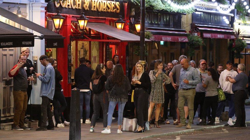 People outside the Coach and Horses pub in Wellington Street, London.