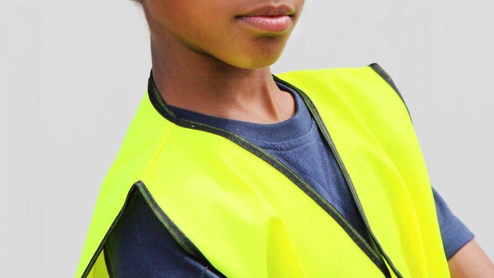 Boy in hi-vis vest