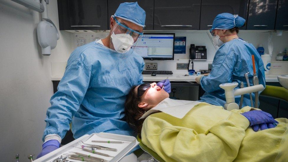 Dentist treating patient