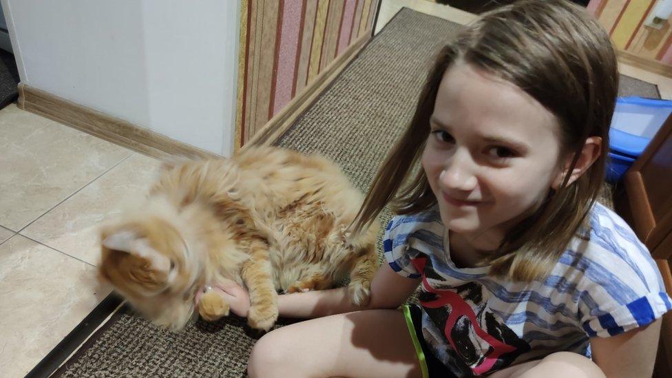 Dasha, 10, with a cat