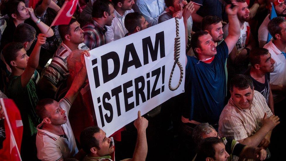 Supporters of Turkish President Recep Tayyip Erdogan hold up a sign saying " We want to execute" at a rally in Kizilay Square in Ankara, Turkey, on Monday