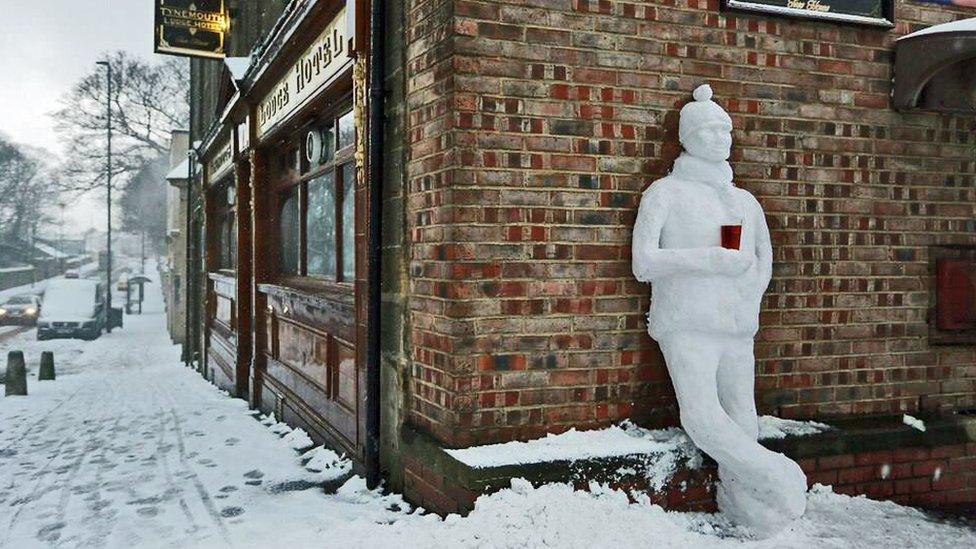 Snowman by pub