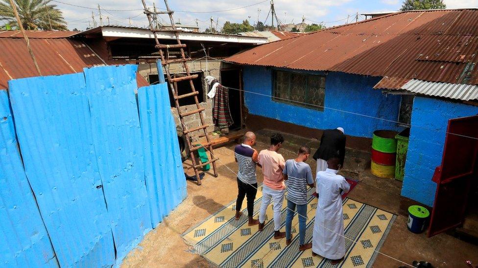 Muslim faithful perform Eid al-Fitr prayers, marking the end of the holy fasting month of Ramadan, at a courtyard within their home as mosques remain closed amid concerns about the spread of the coronavirus disease (COVID-19), in Nairobi, Kenya, May 24, 2020.