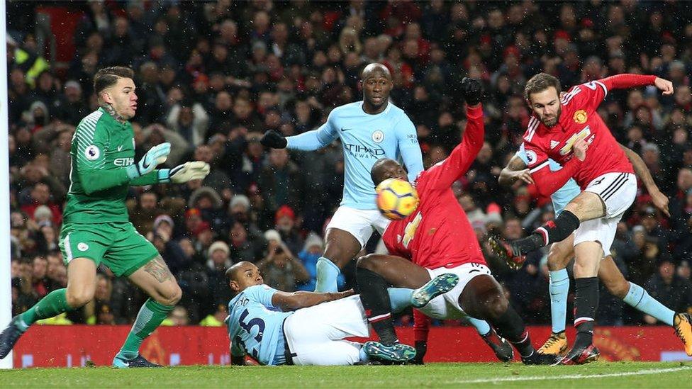 MANCHESTER, ENGLAND - DECEMBER 10: Juan Mata of Manchester United has a shot saved by Ederson of Manchester City during the Premier League match between Manchester United and Manchester City at Old Trafford on December 10, 2017 in Manchester, England.