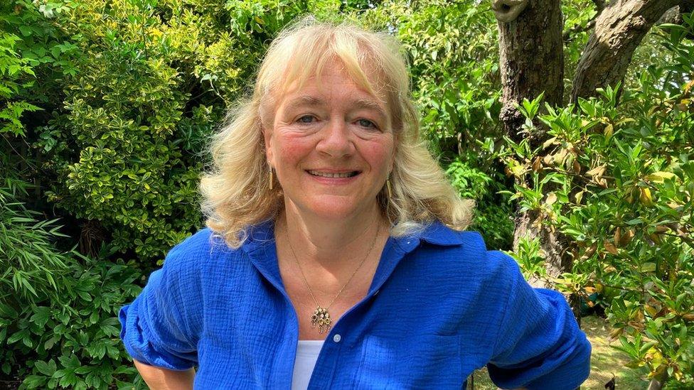 Hazel Leech smiles with a tree behind her