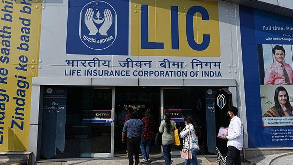 An advertisement of the state-owned insurance group and investment company Life Insurance Corporation (LIC) is pictured at the entrance of a metro station in New Delhi