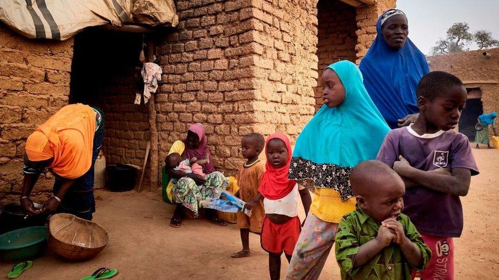 A displaced family is seen in a courtyard of Sevare where they found a shelter after fleeing their village of Guerri in central Mali, on February 27, 2020