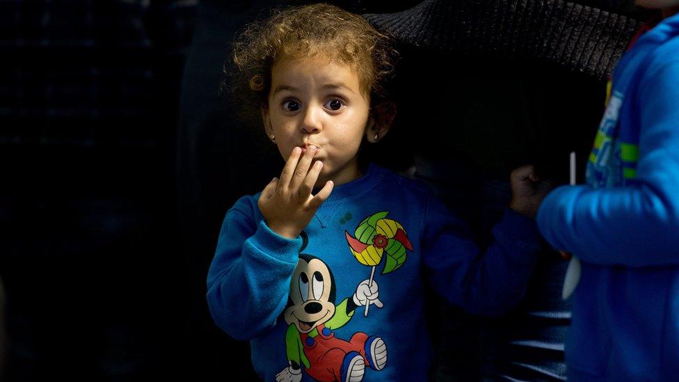 A girl from Syria, who has just arrived by train, waits to travel onto a reception centre, at the central railway station in Munich, Germany, 03 September 2015.