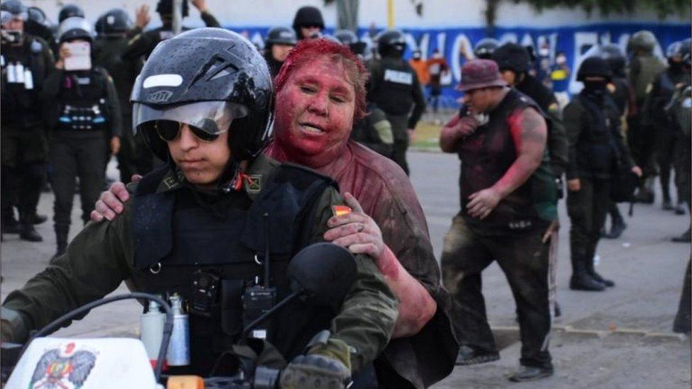 Police took Vinto mayor Patricia Arce Guzman away on a motorcycle after people threw paint at her