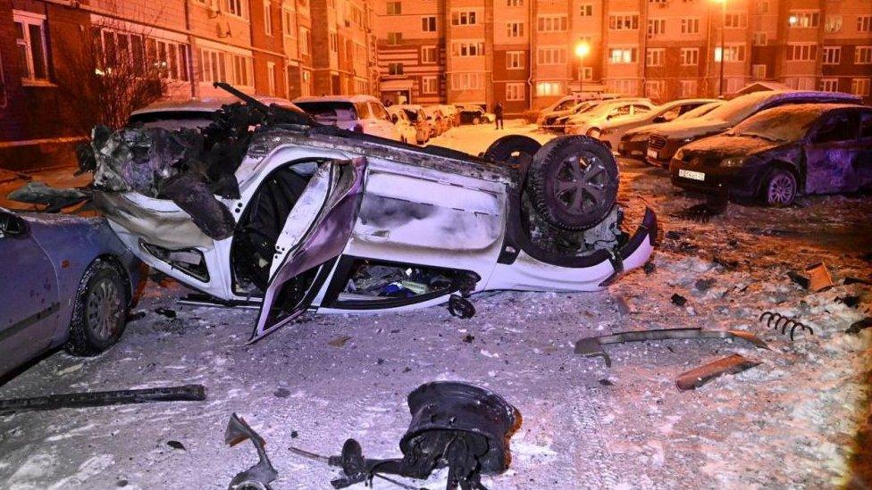 A view shows damaged cars in a courtyard of a multi-story apartment building following what local authorities say was a Ukrainian military strike in the city of Belgorod, Russia, in this picture published January 5, 2024