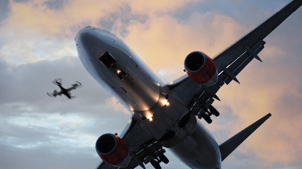 Stock image of a plane with a drone beside it